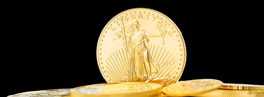 one ounce of golden eagle standing on edge on other golden coins